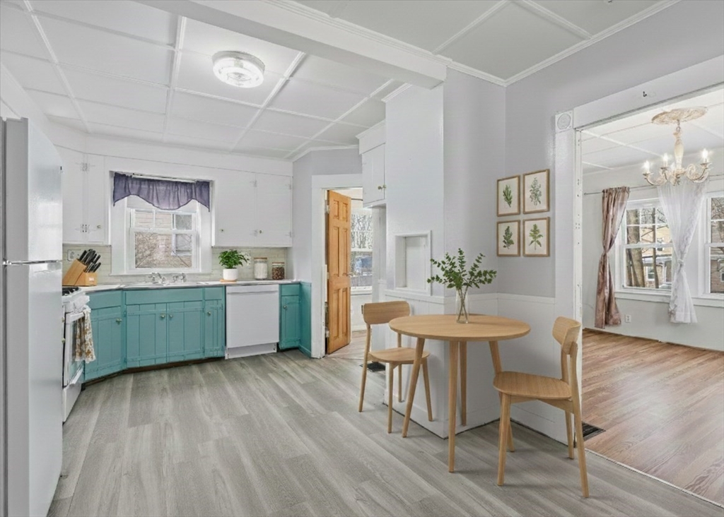 7 Mystic Street Methuen, MA 01844 - Photo 7 of 30 a kitchen with a table chairs sink and cabinets