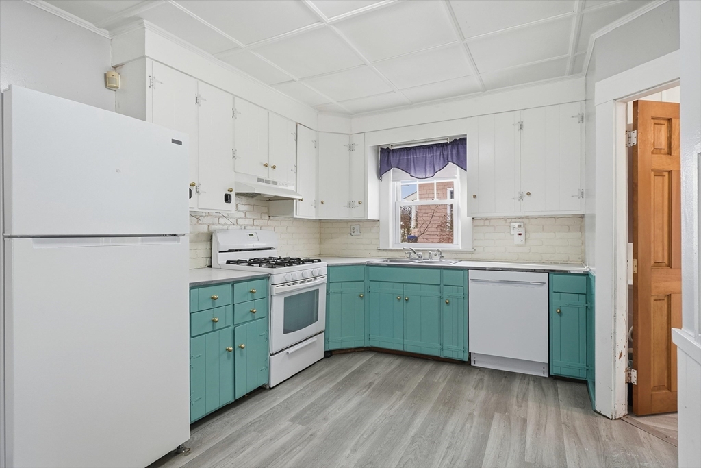 7 Mystic Street Methuen, MA 01844 - Photo 8 of 30 a kitchen with a white cabinets sink and stainless steel appliances