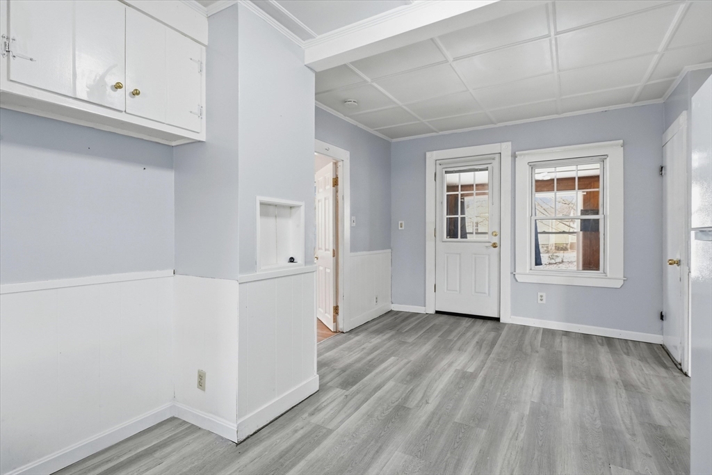 7 Mystic Street Methuen, MA 01844 - Photo 10 of 30 an empty room with wooden floor and cabinet