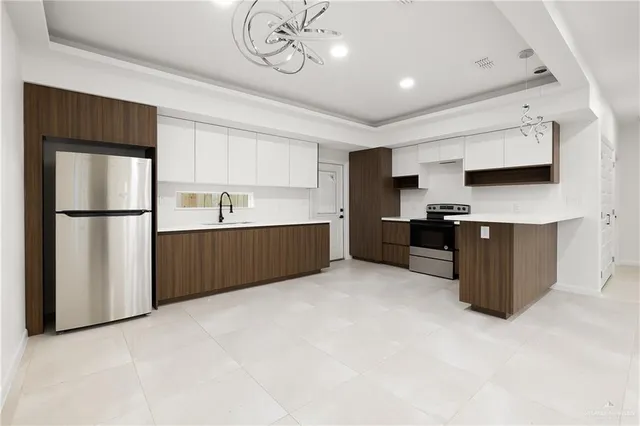 a kitchen with stainless steel appliances a refrigerator and a sink