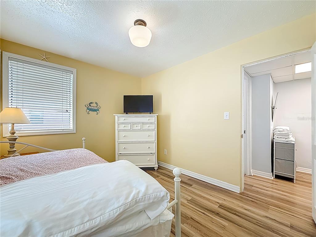 6700 Sunset Way, Unit 604 St. Pete Beach, FL 33706 - Photo 13 of 27 a bedroom with a bed and a television