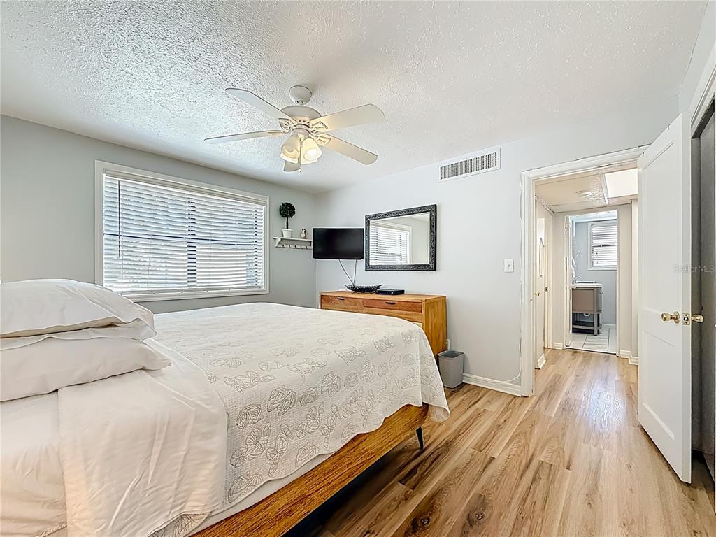 6700 Sunset Way, Unit 604 St. Pete Beach, FL 33706 - Photo 17 of 27 a bedroom with a large bed and a window