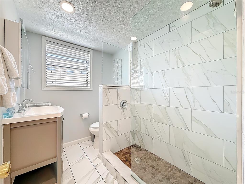 6700 Sunset Way, Unit 604 St. Pete Beach, FL 33706 - Photo 20 of 27 a bathroom with a sink a toilet and window