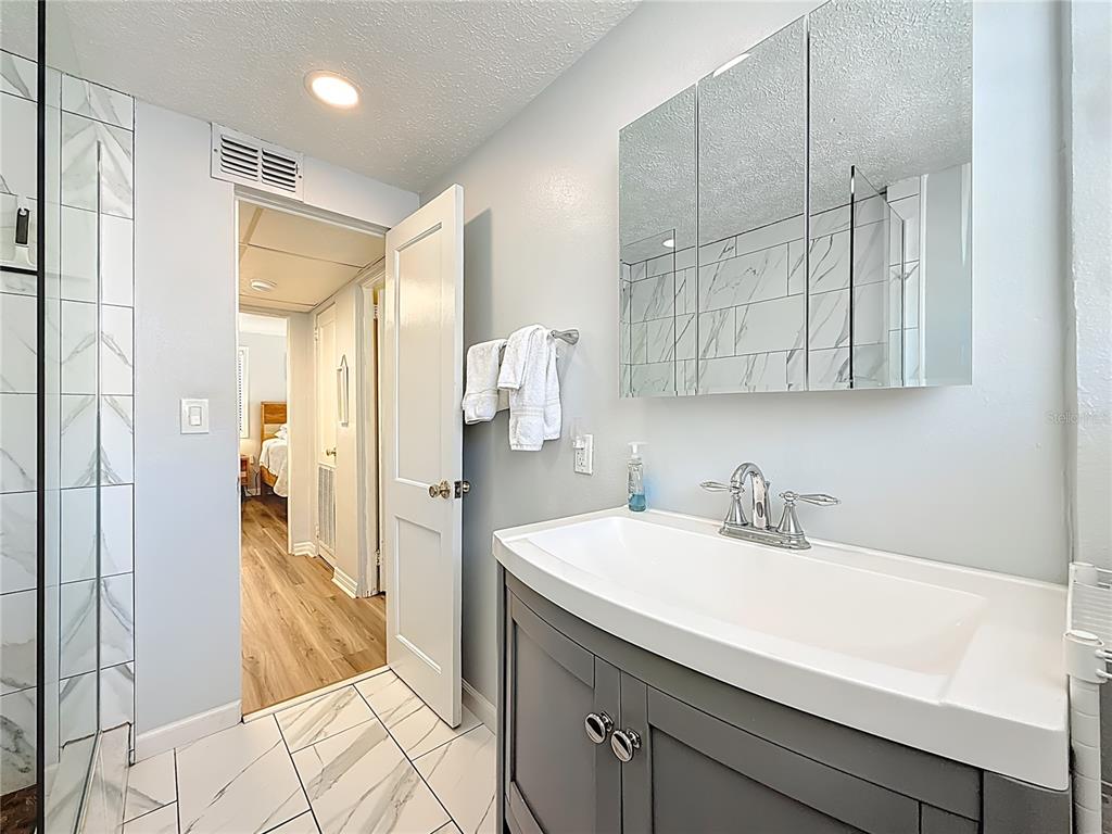 6700 Sunset Way, Unit 604 St. Pete Beach, FL 33706 - Photo 22 of 27 a kitchen with a sink and refrigerator