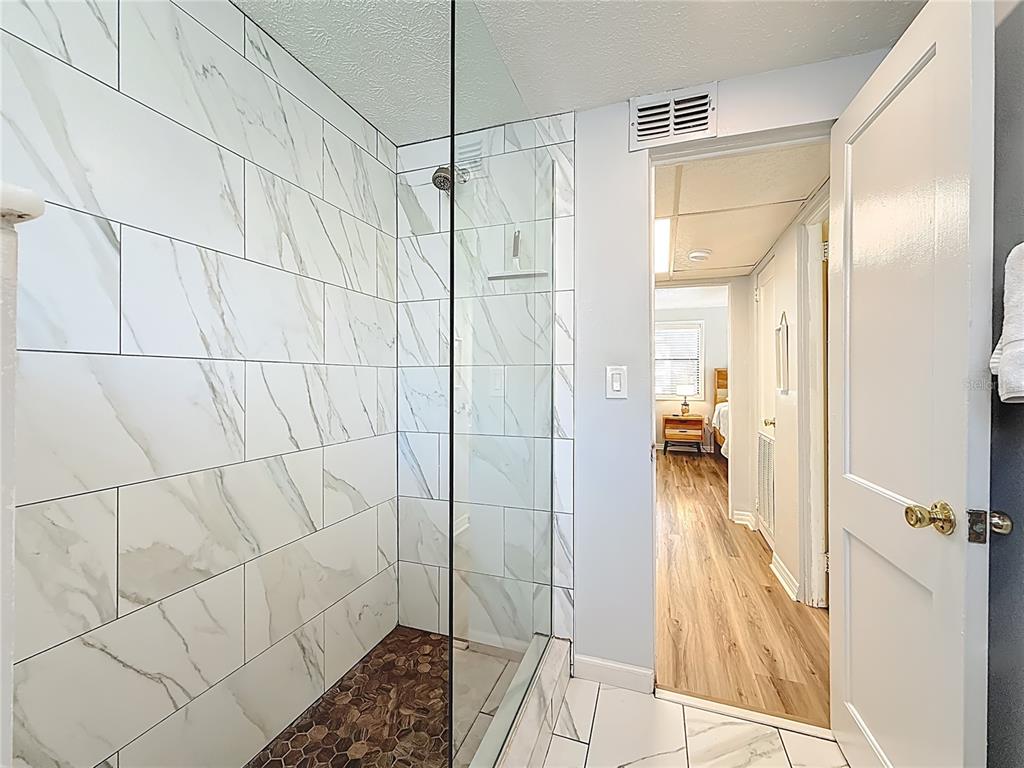6700 Sunset Way, Unit 604 St. Pete Beach, FL 33706 - Photo 23 of 27 a bathroom with a shower