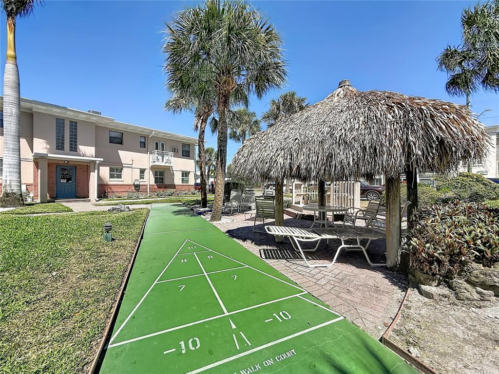 6700 Sunset Way, Unit 604 St. Pete Beach, FL 33706 - Photo 25 of 27 a view of a yard with chairs