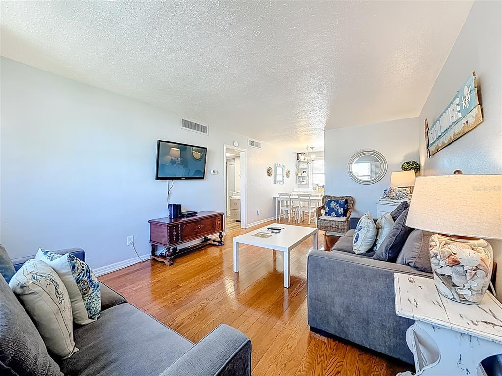 6700 Sunset Way, Unit 604 St. Pete Beach, FL 33706 - Photo 6 of 27 a living room with furniture and a couch