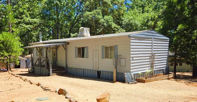 a view of a house with snow on the road