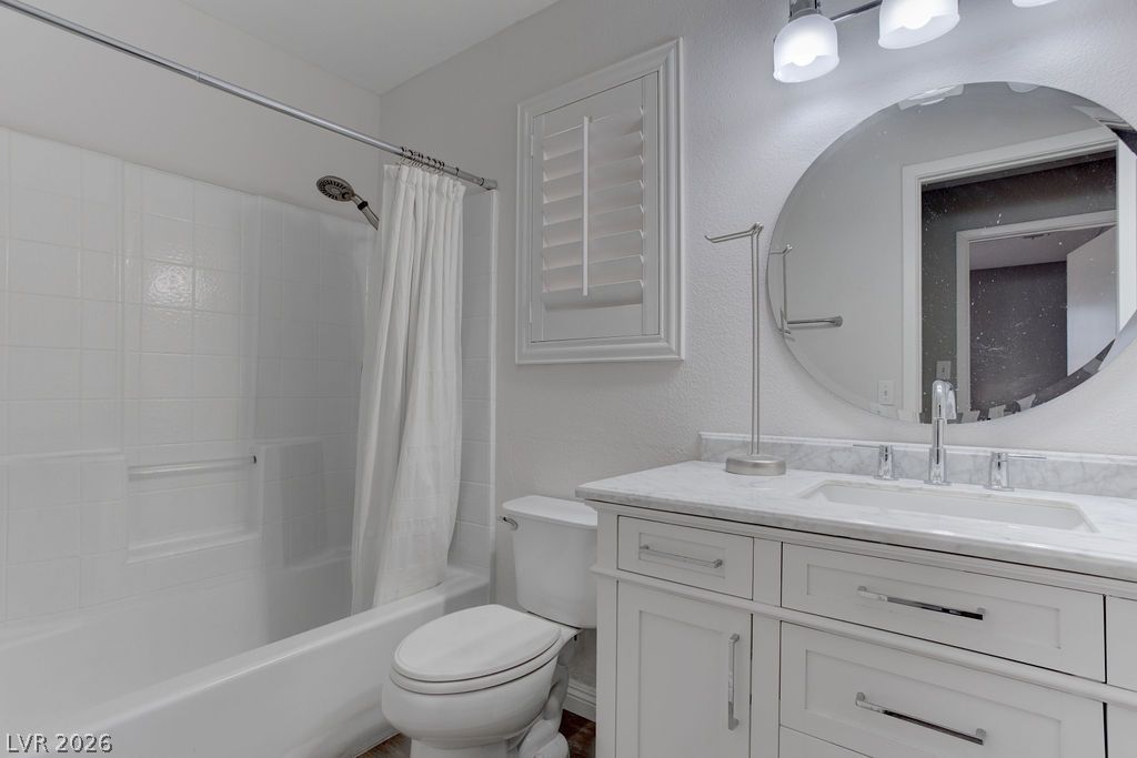 1416 Walstone Road North Las Vegas, NV 89031 - Photo 25 of 47 White subway tile adorns this pristine bathroom, featuring a modern vanity and a sleek toilet.