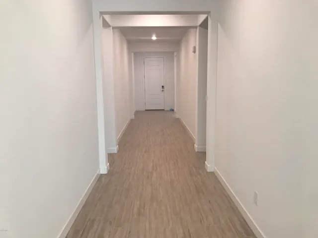a view of a hallway with wooden floor