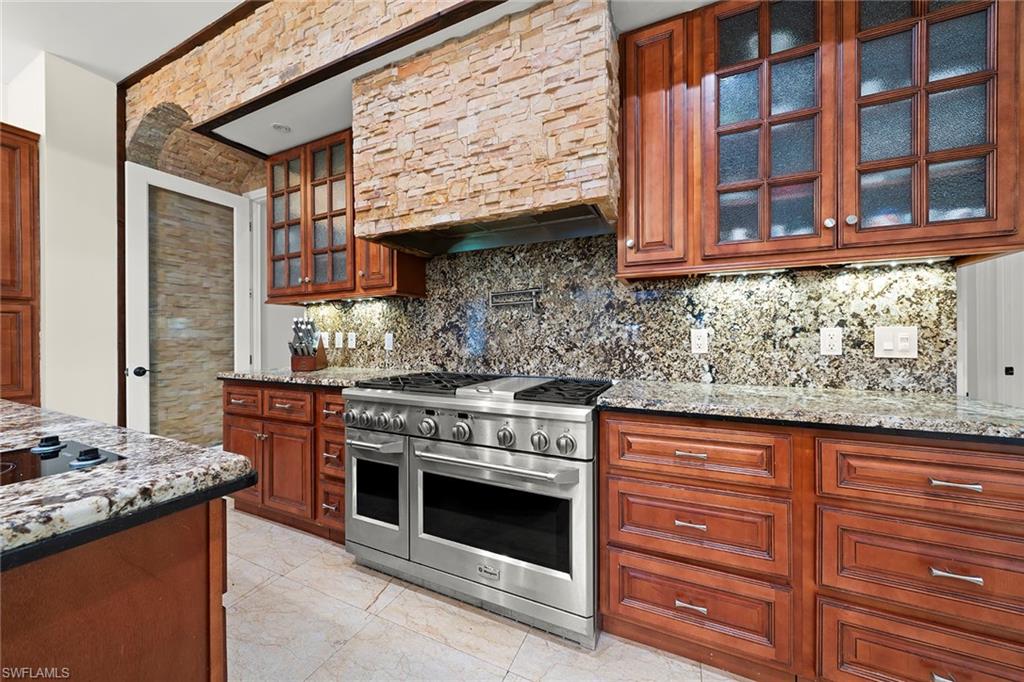 2605 64th Street Southwest Naples, FL 34105 - Photo 14 of 45 a kitchen with stainless steel appliances granite countertop a stove and a sink
