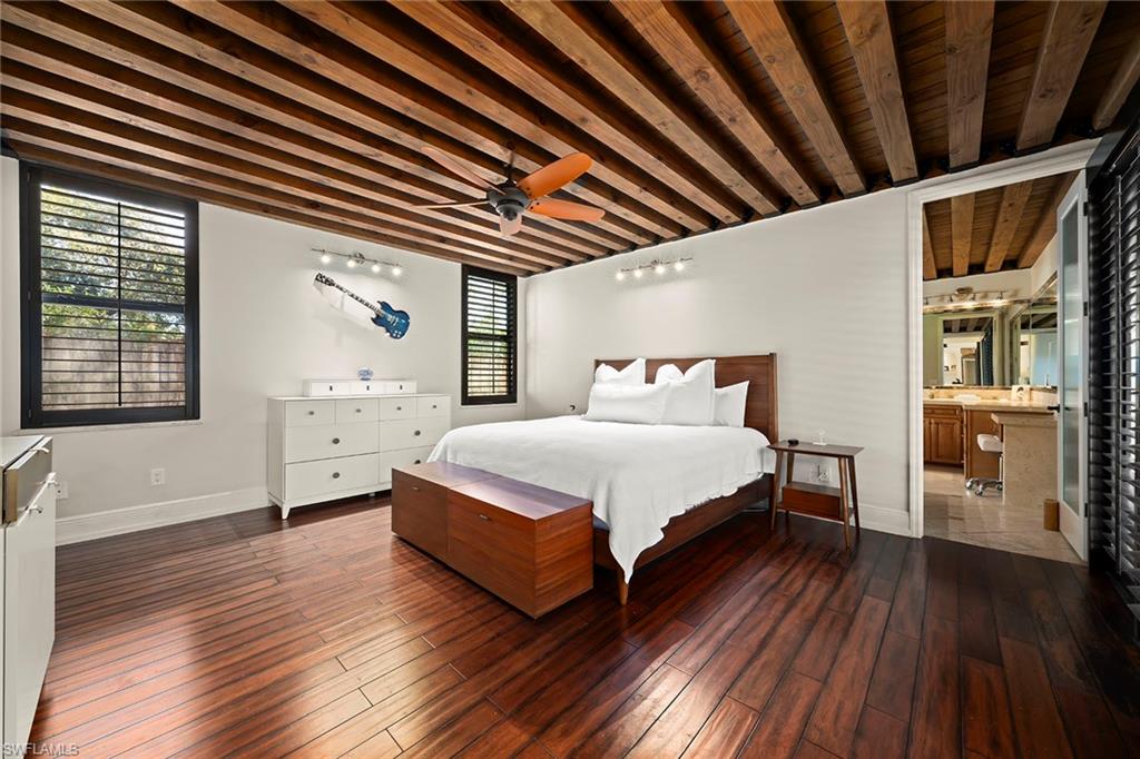 2605 64th Street Southwest Naples, FL 34105 - Photo 19 of 45 a spacious bedroom with a bed and wooden floor