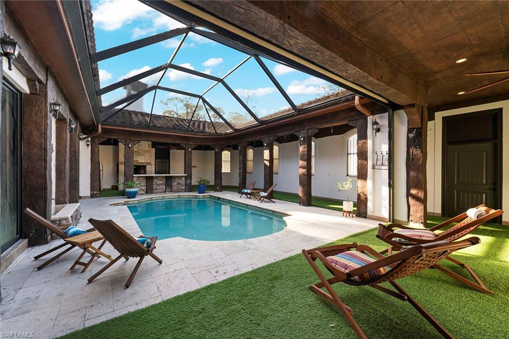 2605 64th Street Southwest Naples, FL 34105 - Photo 41 of 45 a swimming pool with outdoor seating and yard