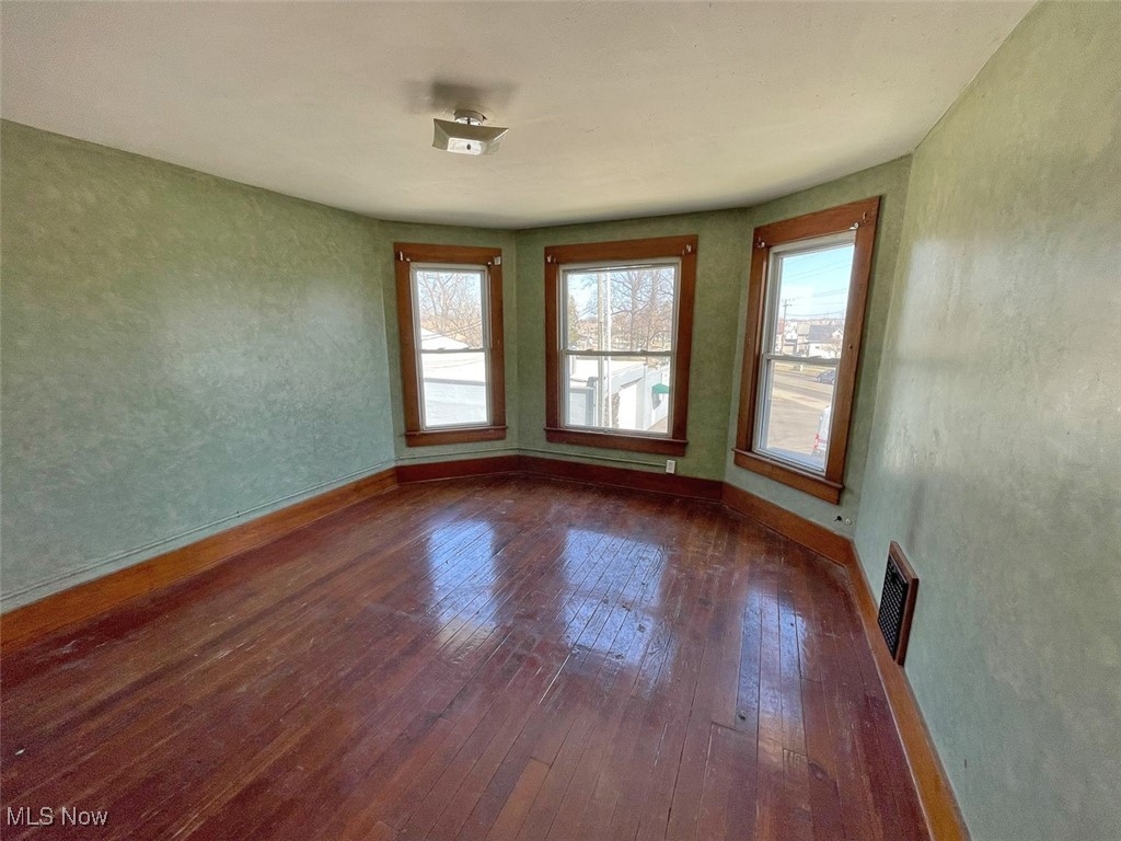 2703 Mahoning Road Northeast Canton, OH 44705 - Photo 14 of 21 Bedroom featuring dark wood-type flooring, baseboards, and visible vents