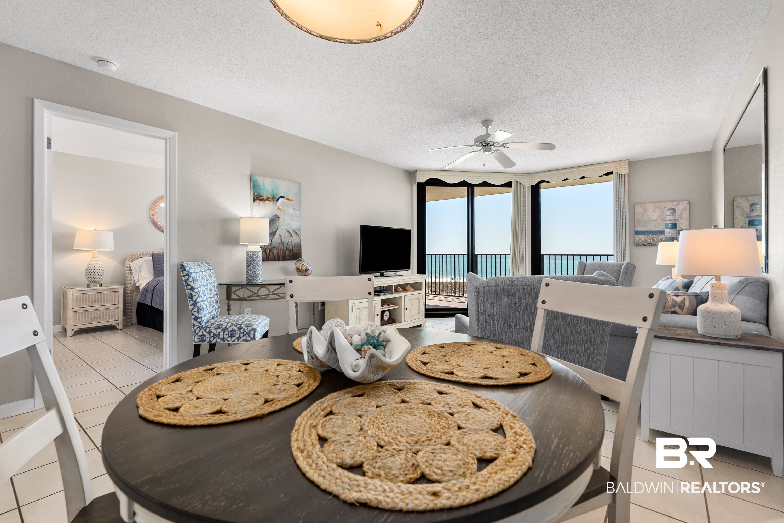 26802 Perdido Beach Boulevard, Unit 406 Orange Beach, AL 36561 - Photo 8 of 37 Dining room featuring light tile patterned floors, a textured ceiling, and a ceiling fan