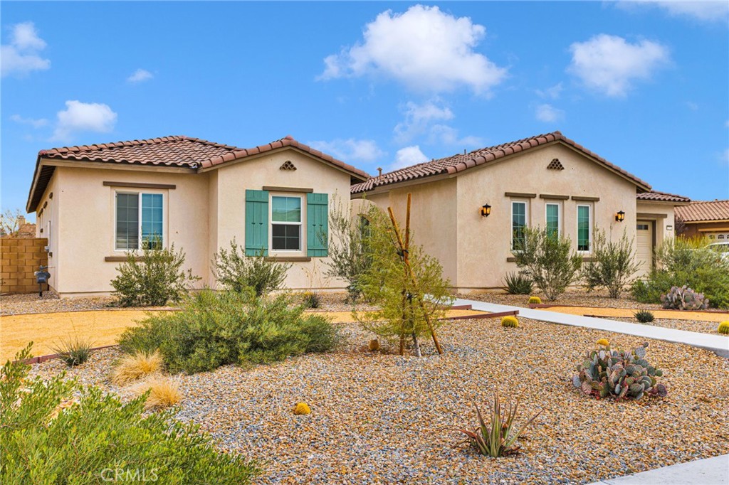 12925 Davona Dale Road Apple Valley, CA 92308 - Photo 2 of 44 a front view of a house with a yard