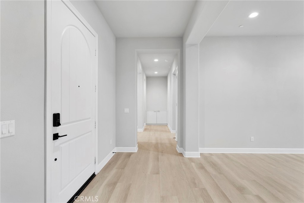 12925 Davona Dale Road Apple Valley, CA 92308 - Photo 26 of 44 a view of a hallway with wooden floor and closet