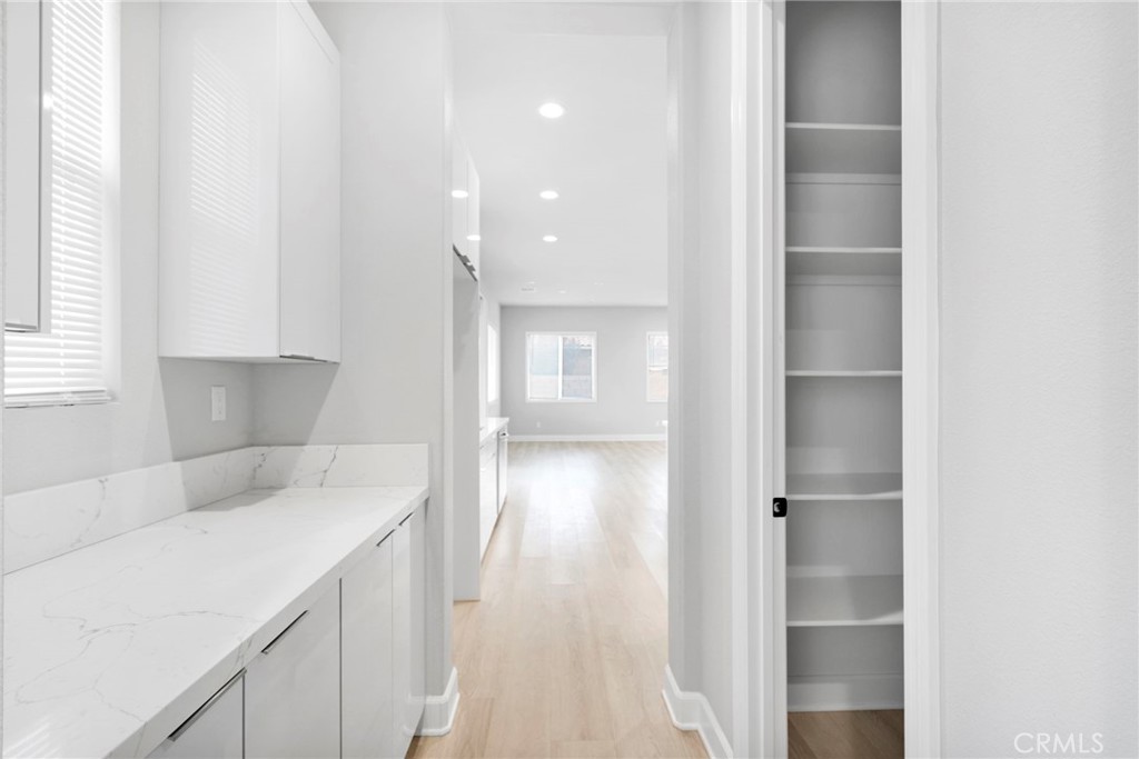 12925 Davona Dale Road Apple Valley, CA 92308 - Photo 8 of 44 a kitchen with a refrigerator and window