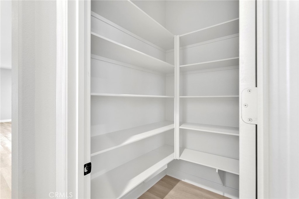 12925 Davona Dale Road Apple Valley, CA 92308 - Photo 9 of 44 a view of walk in closet with empty racks