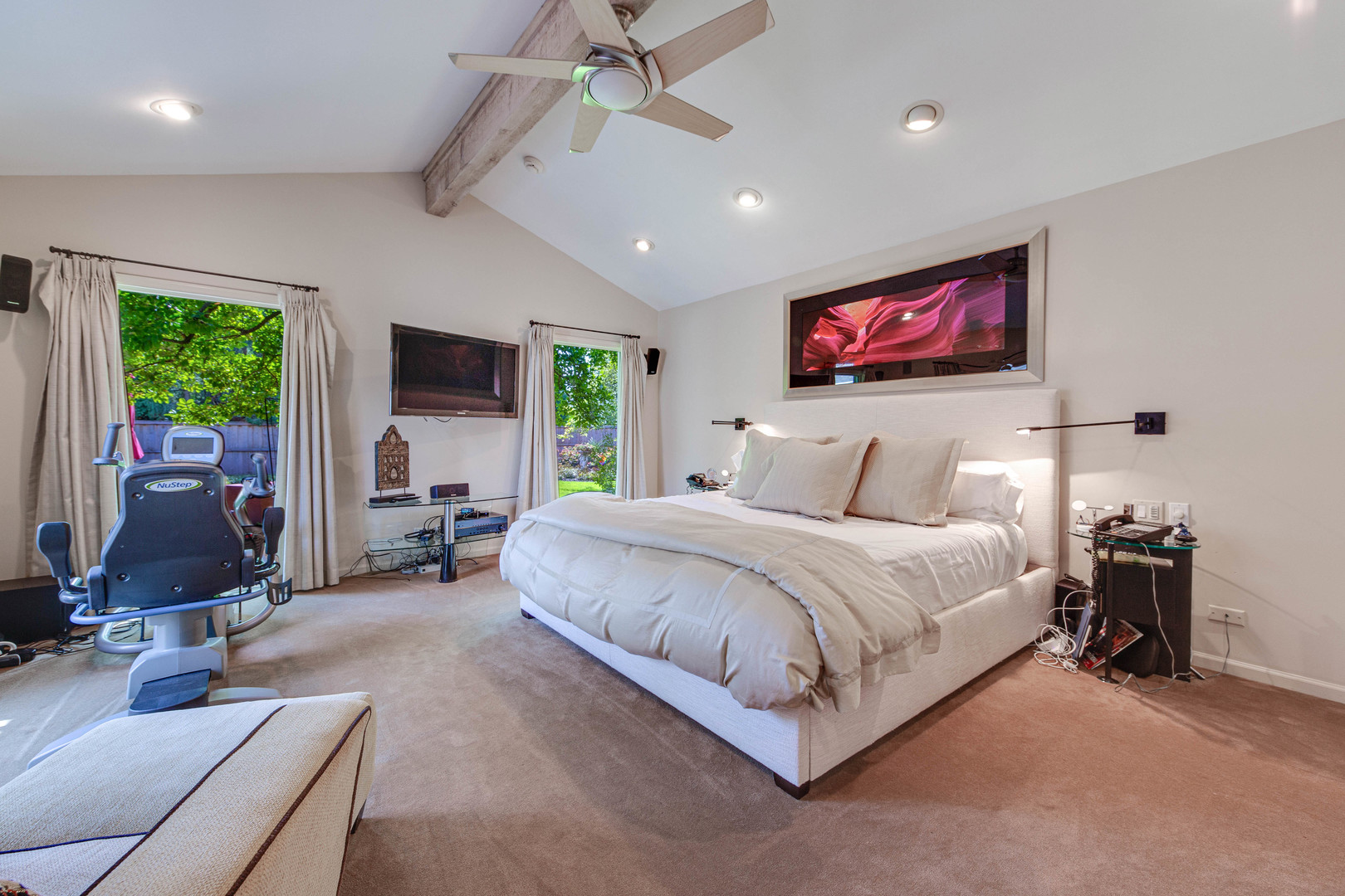 1144 Mayfair Lane Glencoe, IL 60022 - Photo 14 of 23 a spacious bedroom with a bed a couch and a flat screen tv