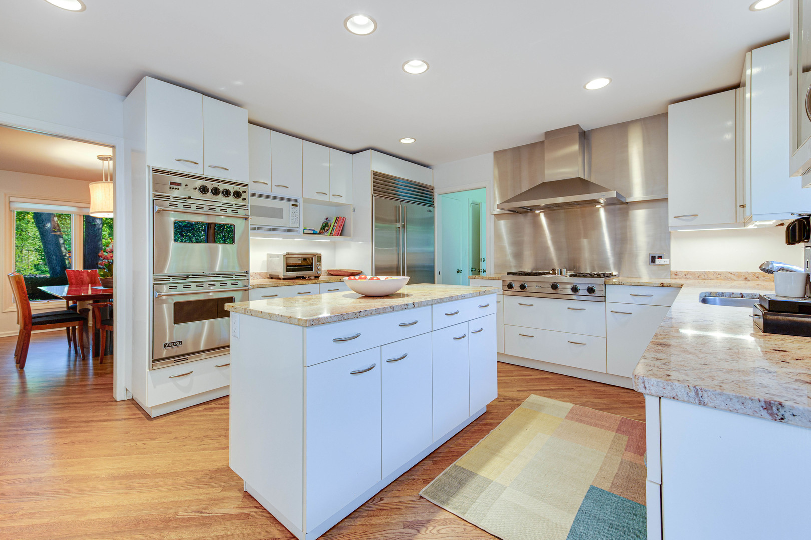 1144 Mayfair Lane Glencoe, IL 60022 - Photo 9 of 23 a kitchen with stainless steel appliances granite countertop a refrigerator oven a sink dishwasher and white cabinets with wooden floor