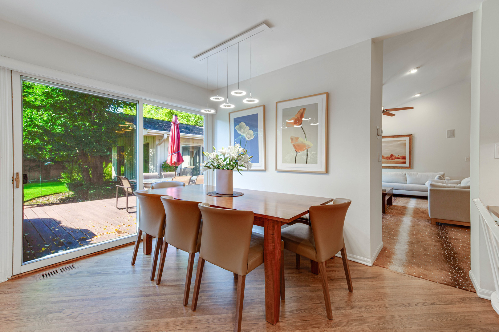 1144 Mayfair Lane Glencoe, IL 60022 - Photo 10 of 23 a dining room with wooden floor a chandelier a glass table and chairs