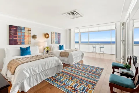 a bedroom with two beds and a couch