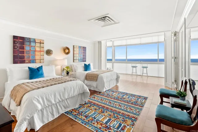 a bedroom with two beds and a couch