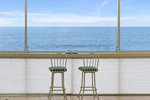 a bathroom with a granite countertop sink a toilet and a shower curtain
