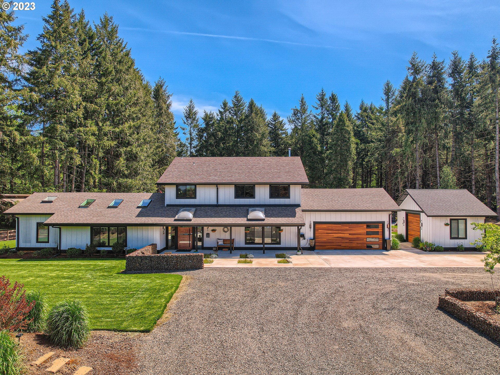 a front view of a residential houses with yard and trees