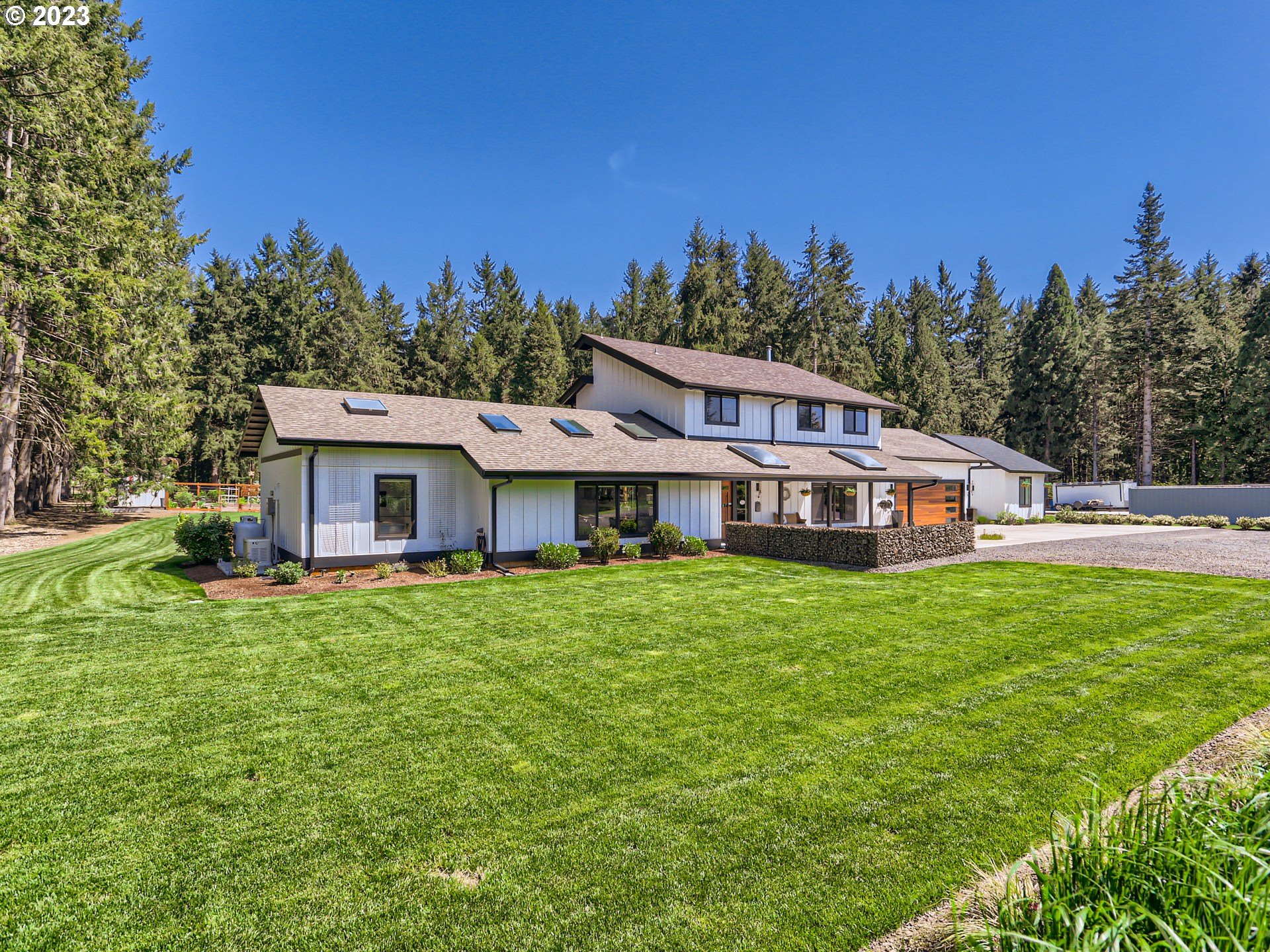 15631 Northeast Becke Road Aurora, OR 97002 - Photo 3 of 47 a view of a house with a big yard and large trees
