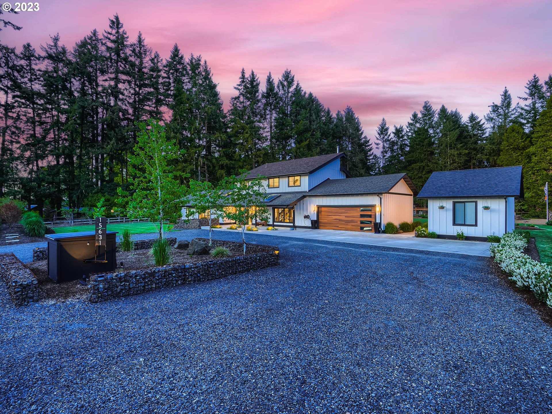 15631 Northeast Becke Road Aurora, OR 97002 - Photo 5 of 47 a view of a house with a yard and a forest