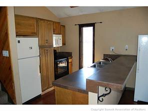 172 Alpine Road Dillon, CO 80435 - Photo 12 of 18 a kitchen with kitchen island a sink appliances and cabinets