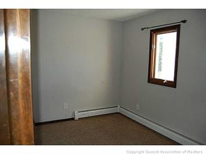 172 Alpine Road Dillon, CO 80435 - Photo 8 of 18 a view of an empty room with wooden floor and a window
