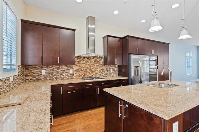 a kitchen with stainless steel appliances granite countertop a sink counter space and refrigerator