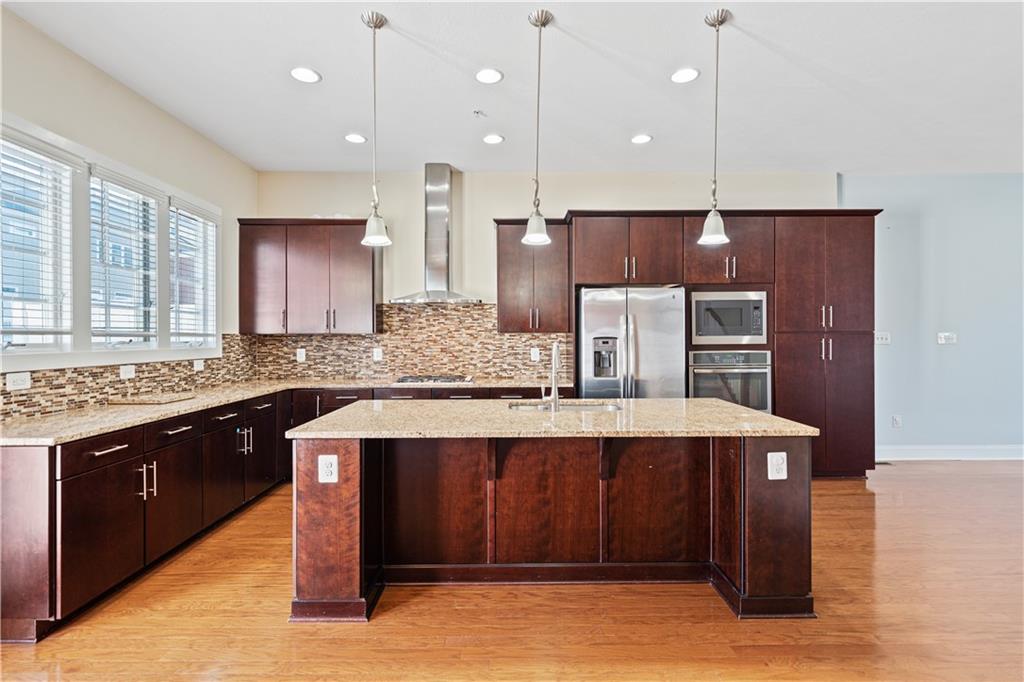 337 Osana Lane Mars, PA 16046 - Photo 18 of 34 a kitchen with kitchen island granite countertop wooden cabinets and stainless steel appliances