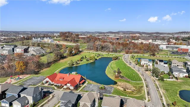 an aerial view of a houses with a swimming pool