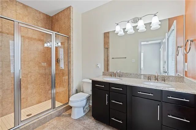 a bathroom with a double vanity sink mirror and toilet