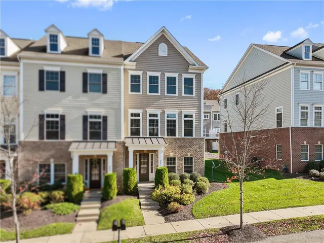 a front view of a residential apartment building with a yard