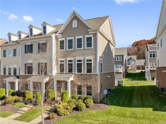 a front view of a residential apartment building with a yard