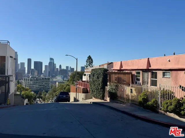 a view of a house with yard and sitting area