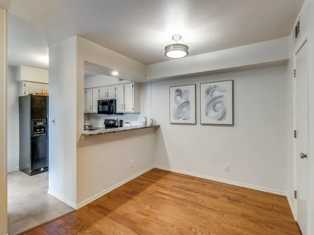 a view of a kitchen with microwave and cabinets