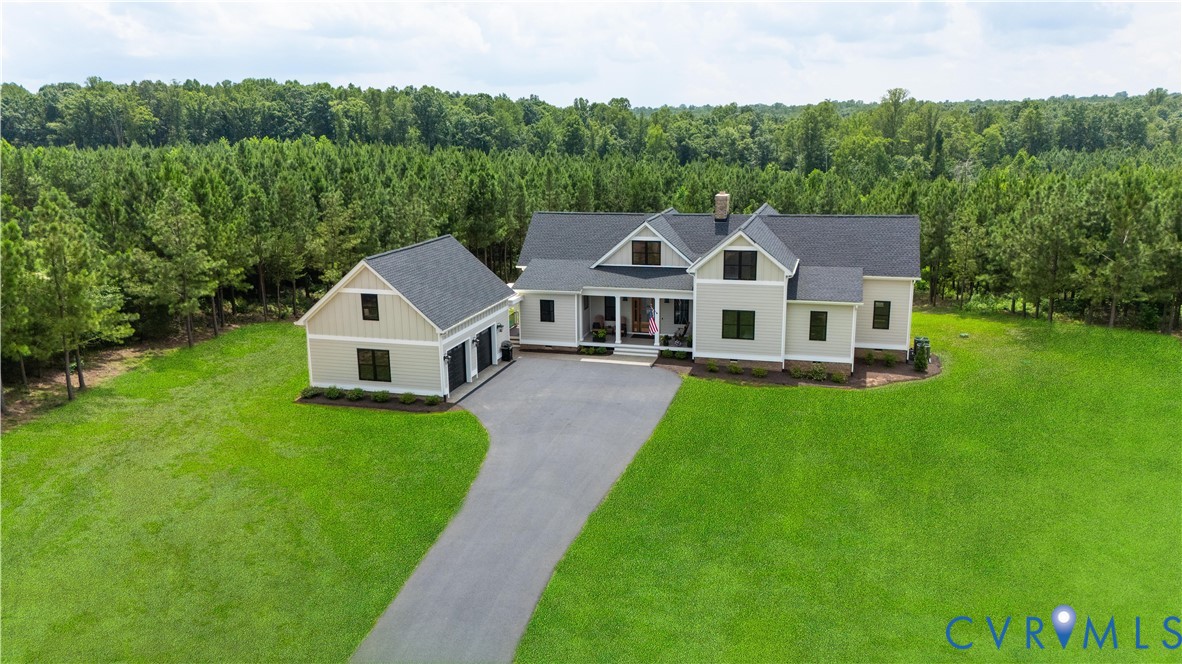 1551 Smokey Rdg Road Maidens, VA 23102 - Photo 45 of 49 a front view of a house with a garden and trees