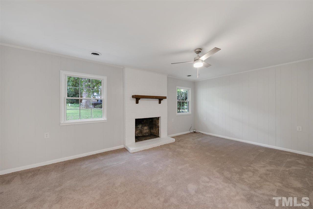 7409 Fiesta Way Raleigh, NC 27615 - Photo 11 of 30 an empty room with windows and fireplace