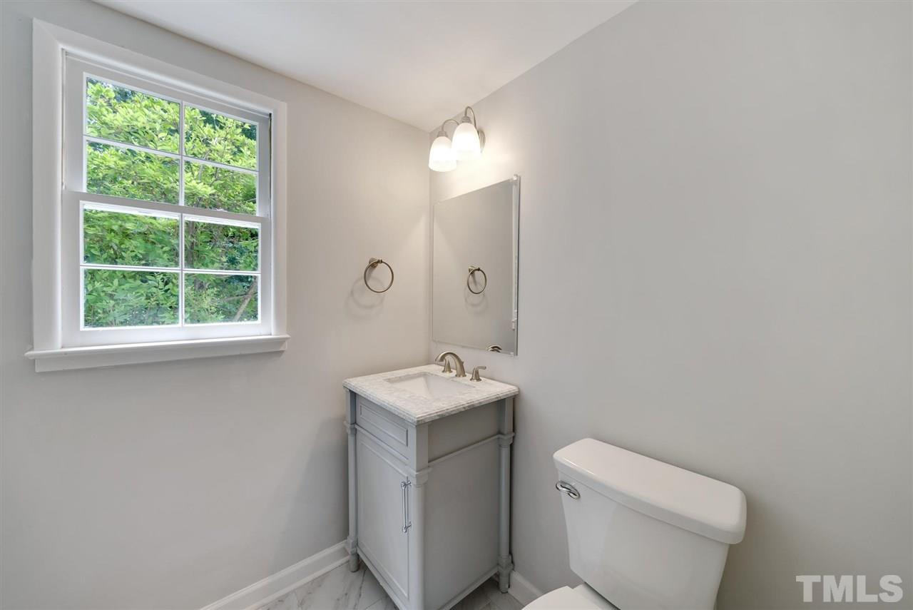 7409 Fiesta Way Raleigh, NC 27615 - Photo 13 of 30 a bathroom with a sink toilet and a mirror