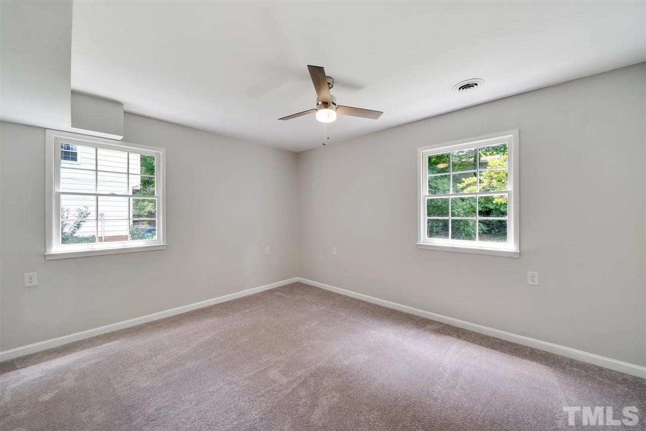 7409 Fiesta Way Raleigh, NC 27615 - Photo 14 of 30 an empty room with a window and a ceiling fan
