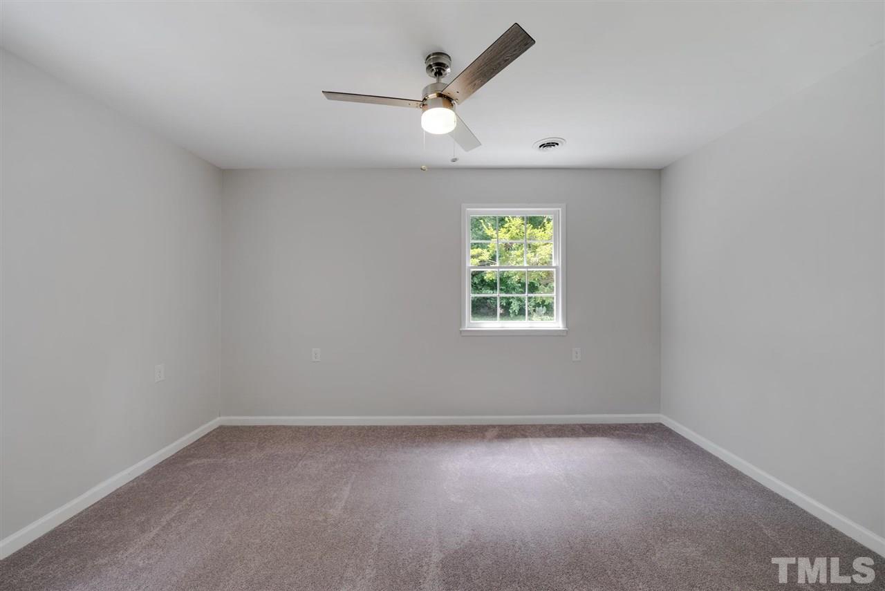 7409 Fiesta Way Raleigh, NC 27615 - Photo 15 of 30 an empty room with a window and a ceiling fan
