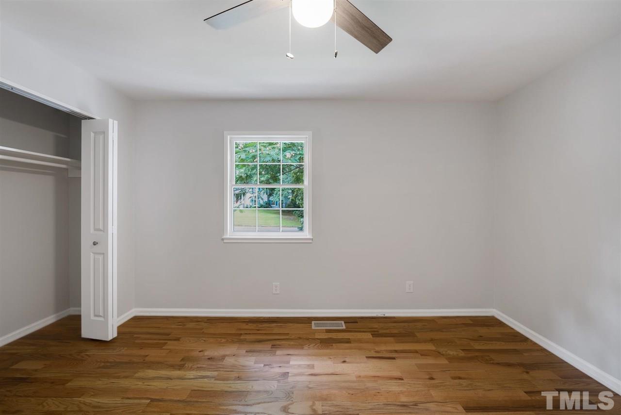 7409 Fiesta Way Raleigh, NC 27615 - Photo 20 of 30 a view of an empty room with wooden floor and a window