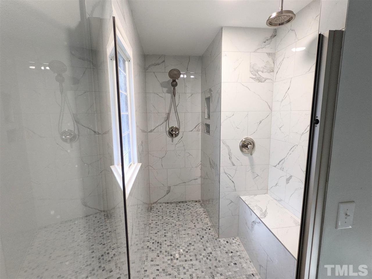 7409 Fiesta Way Raleigh, NC 27615 - Photo 24 of 30 a bathroom with a shower and a sink