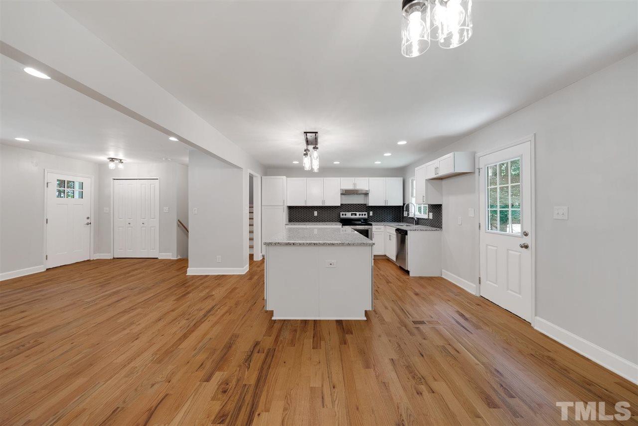 7409 Fiesta Way Raleigh, NC 27615 - Photo 5 of 30 a view of kitchen with wooden floor and a sink